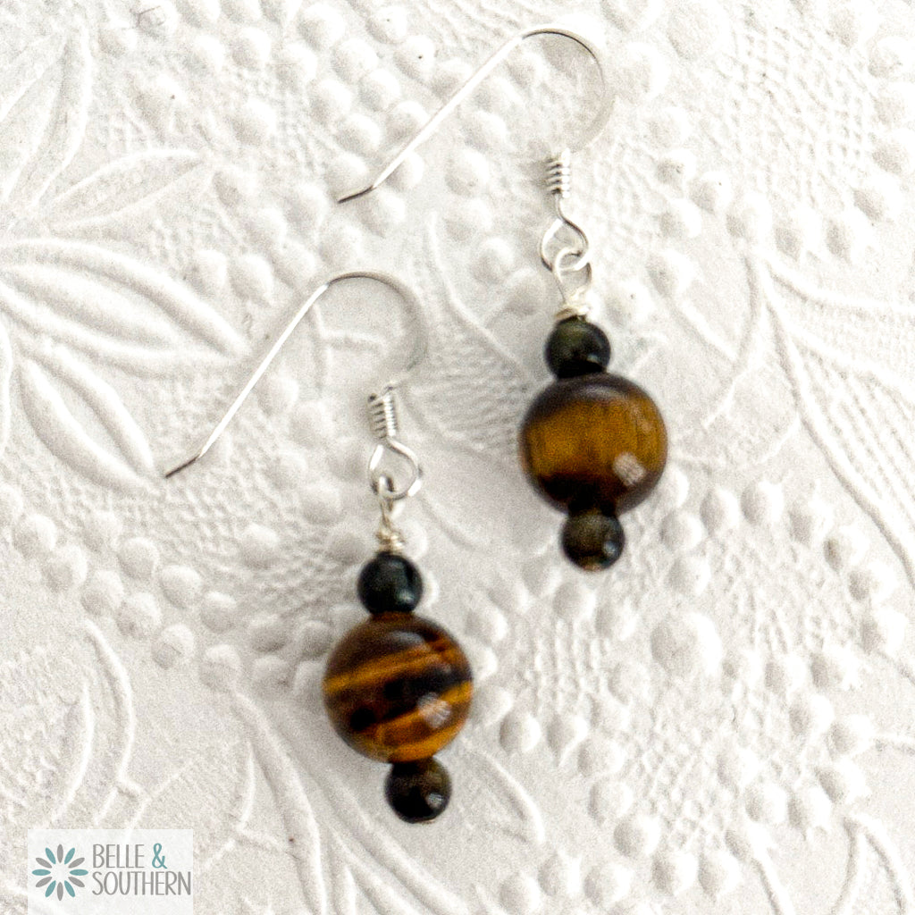 Beaded earrings with tiger eye stones on a textured white background, featuring the brand 'Belle & Southern'.