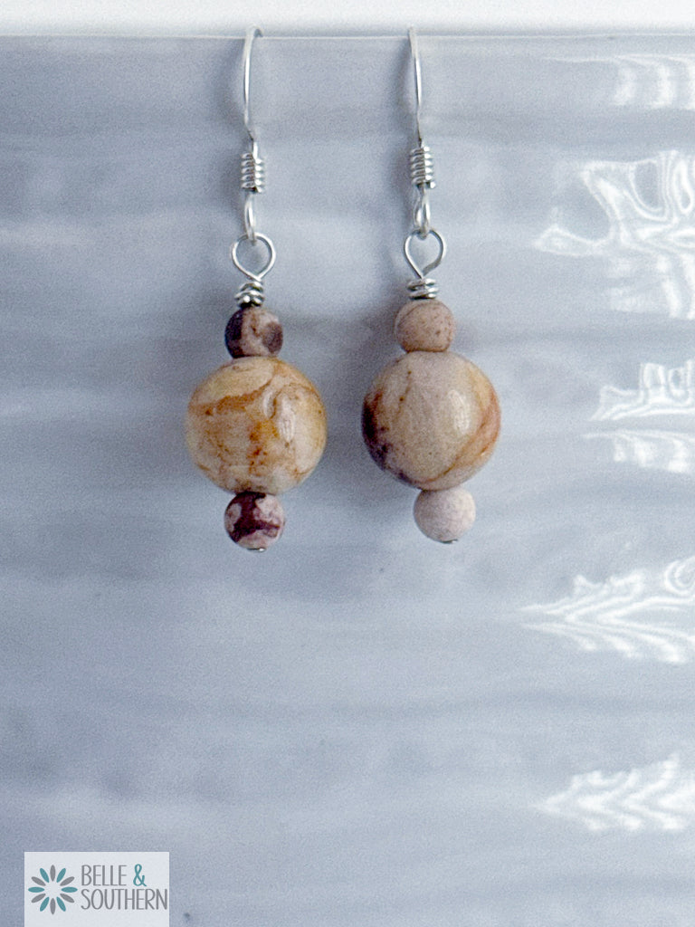 Pair of Zebra Jasper Stone bead earrings on a white vase with 'Belle & Southern' branding.