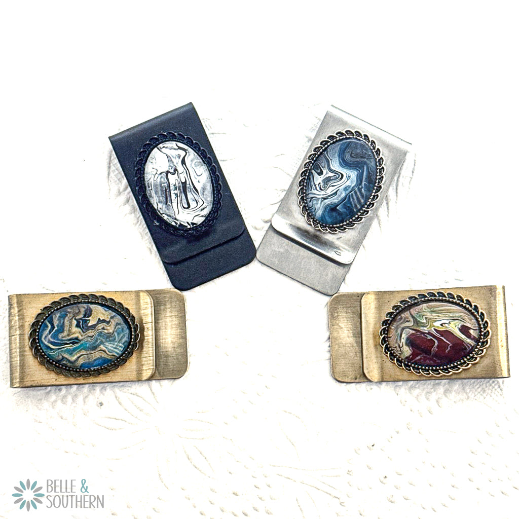 Four money clips with engraved designs on a white background, featuring the brand 'Belle & Southern'.