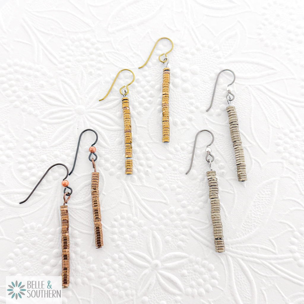 Pair of Copper, Gold and Titanium Stacked Hematite Stone Earrings on a textured white background featuring 'Belle and Southern' brand