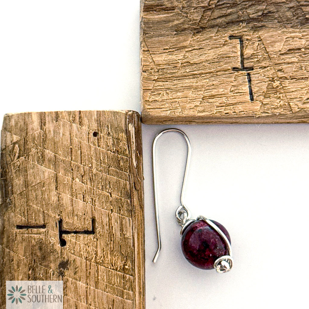 Silver earring with a Aggie Maroon Jade gemstone on next to a ruler, with 'Belle & Southern' branding.