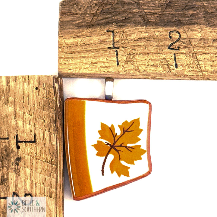 Square pendant with leaf design by wooden measurement markings ruler
