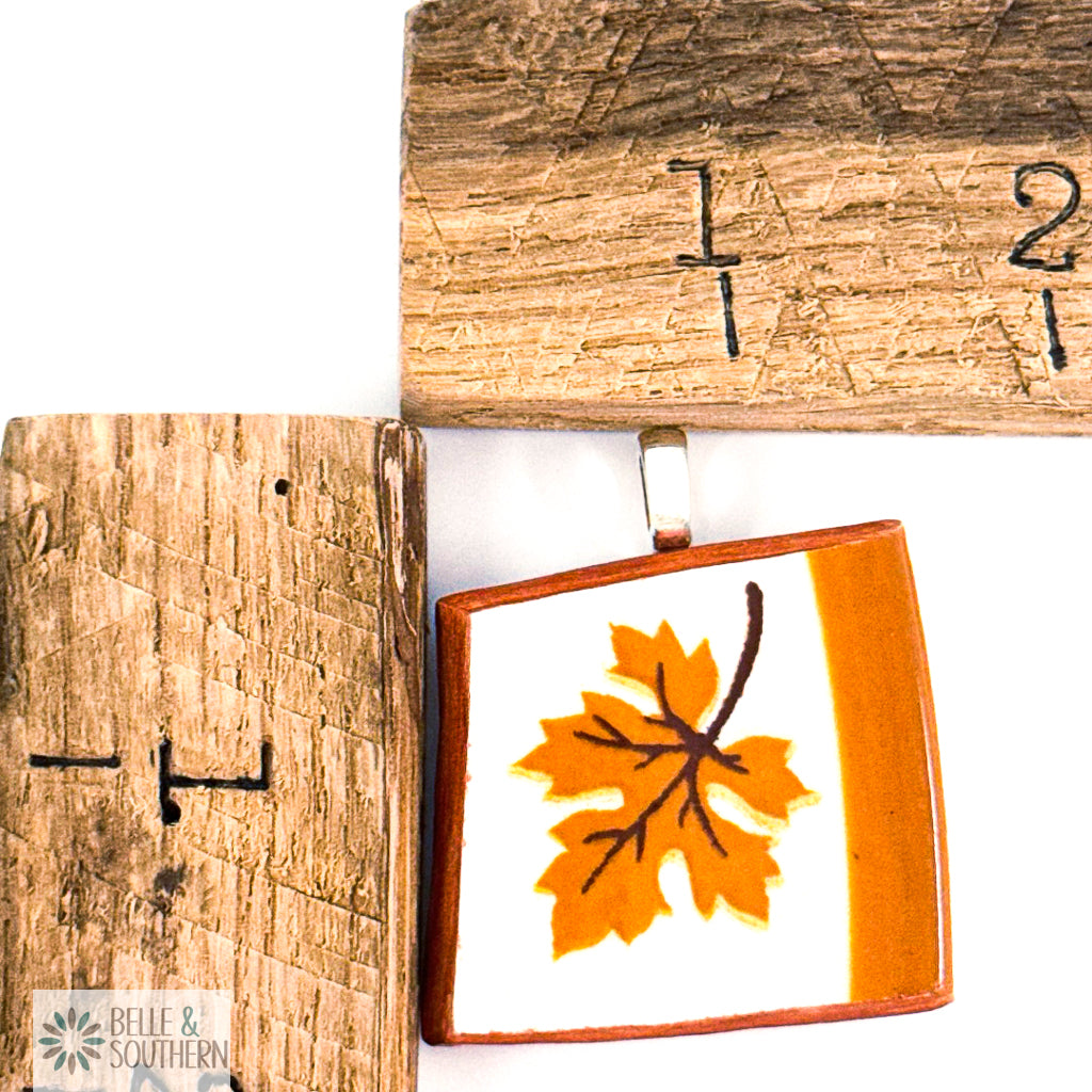 Pendant with orange leaf design by wooden rulers
