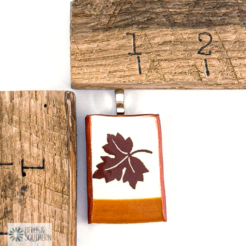 Pendant with leaf design by wooden rulers
