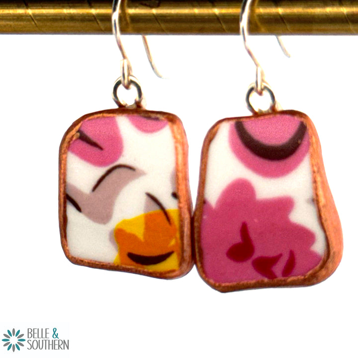 broken plate pink and orange flower earrings on bar