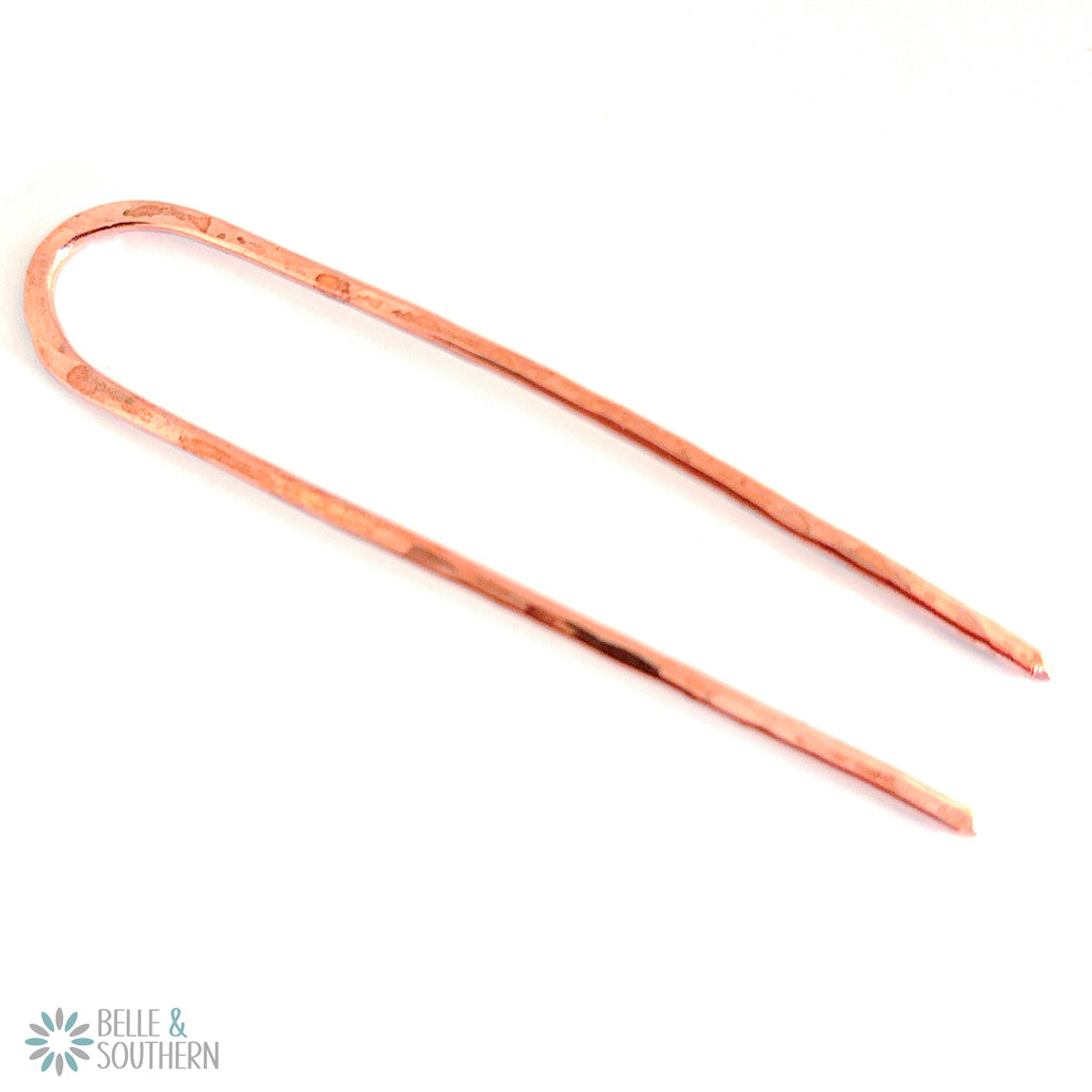 Copper French Hair Pin on white surface
