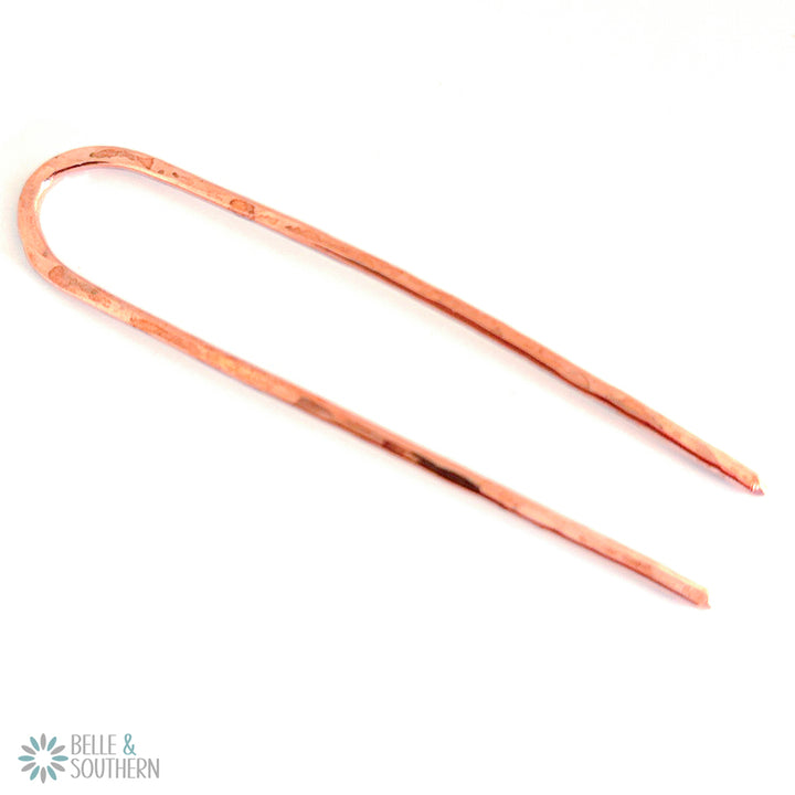 Copper French Hair Pin on white surface
