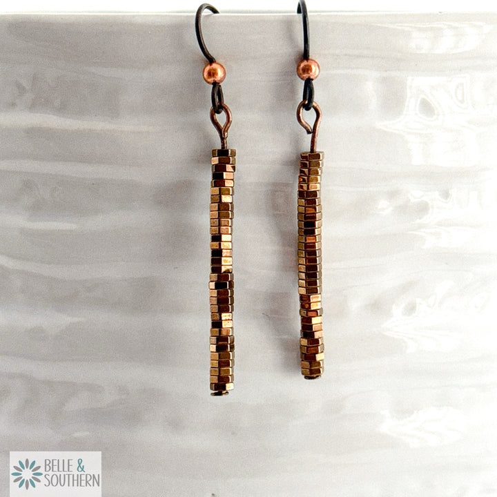 Copper Stacked Hematite Earrings on white vase featuring 'Belle and Southern' brand
