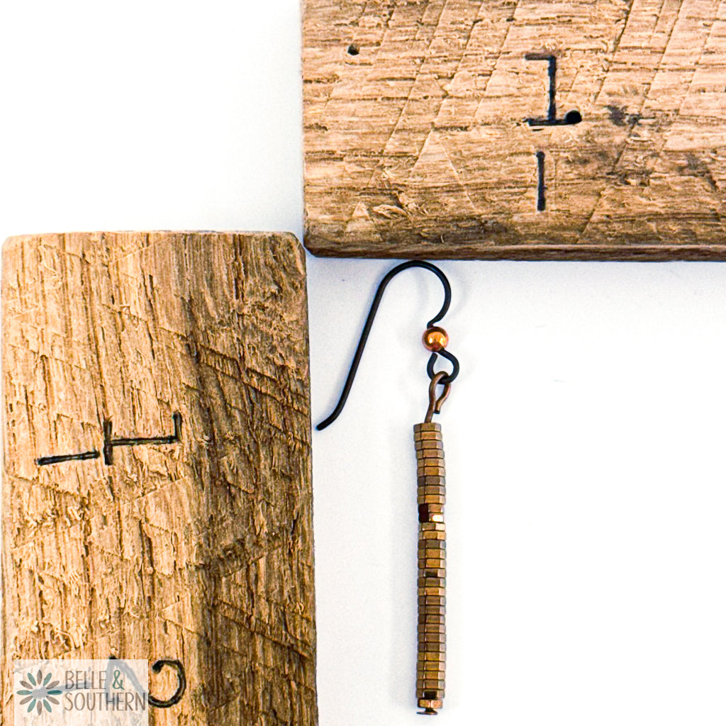 Copper Hematite Stack Earring next to wooden ruler featuring 'Belle and Southern' brand