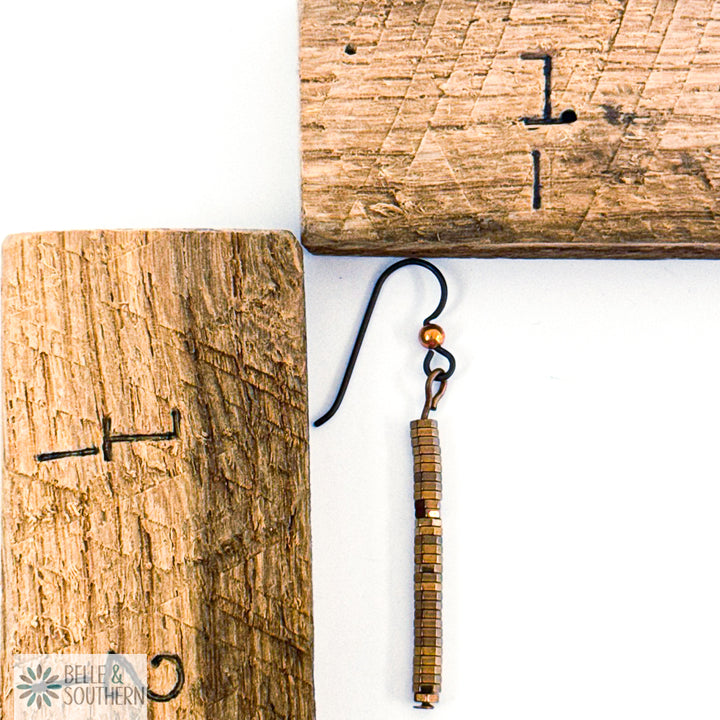 Copper Hematite Stack Earring next to wooden ruler featuring 'Belle and Southern' brand
