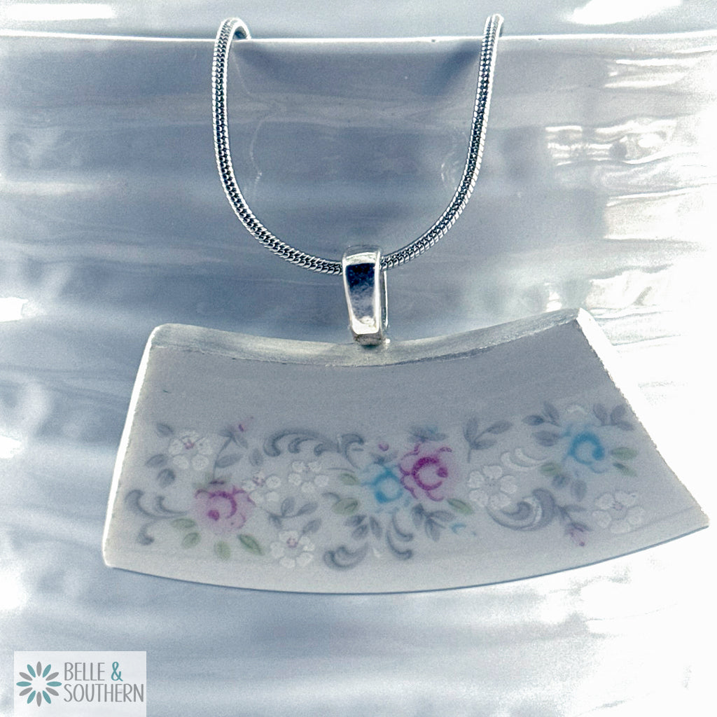 Crescent Garden Fragment Necklace on white vase
