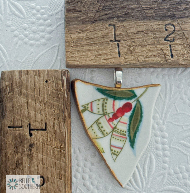 Ceramic pendant with leaf design on a textured surface with 'Belle & Southern' branding.