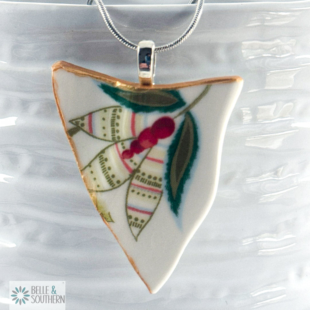 Triangular pendant with floral design on a ceramic bowl, featuring the brand 'Belle & Southern'.