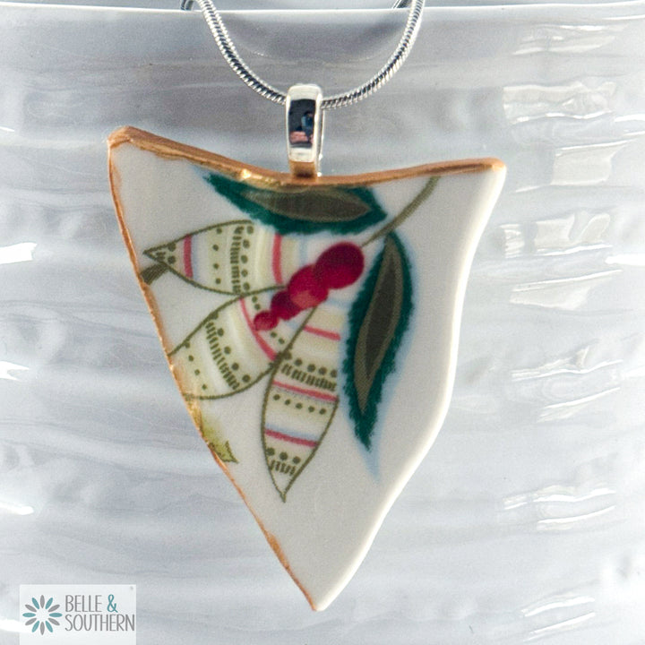 Triangular pendant with floral design on a ceramic bowl, featuring the brand 'Belle & Southern'.