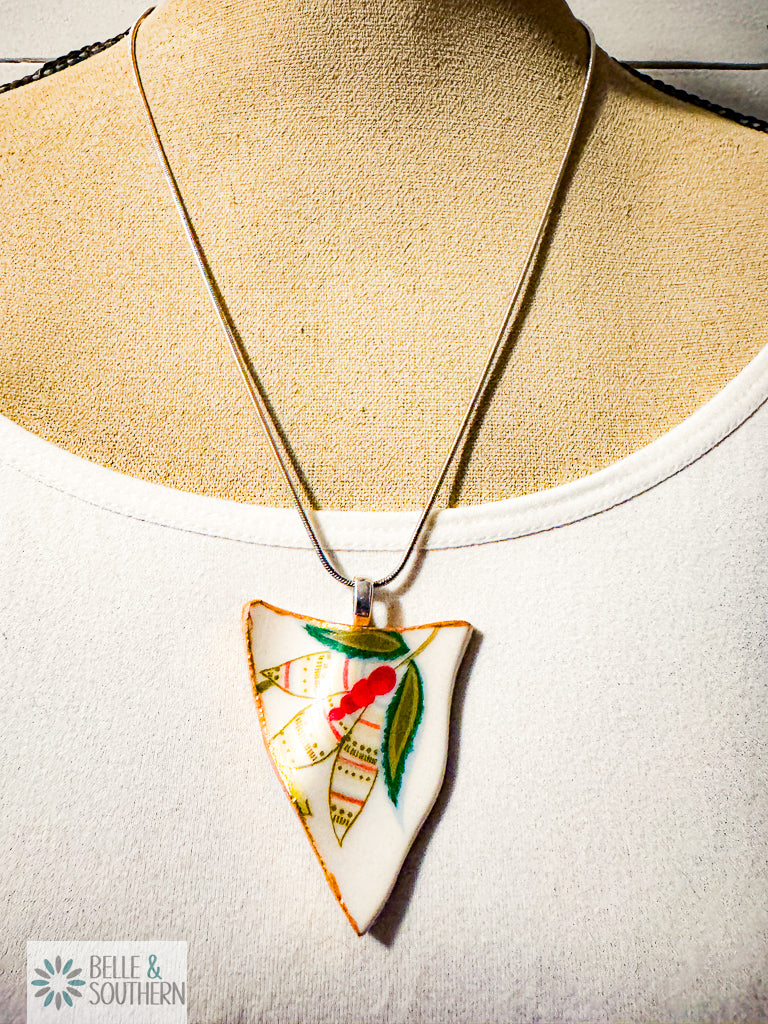 Necklace with a decorative pendant on a mannequin bust, featuring the brand 'Belle & Southern'.