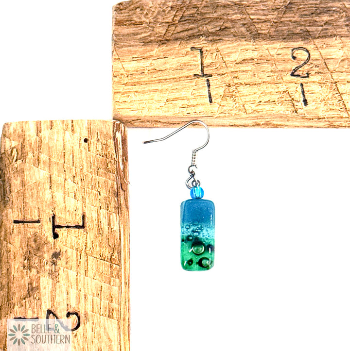 Small Rectangle Slate Blue and Green Fused Glass Earrings next to measuring ruler featuring Belle and Southern Brand