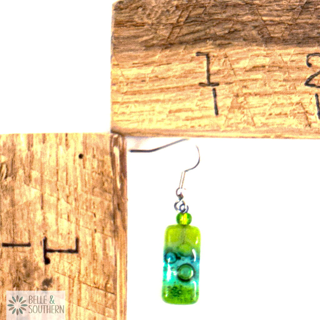 Small Rectangle Light Green and Blue Fused Glass Earrings next to measuring ruler featuring Belle and Southern Brand