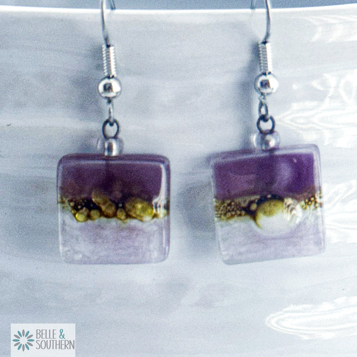 Dark lavender, gold, and light lavender fused small square glass earrings on stainless steel ear wire