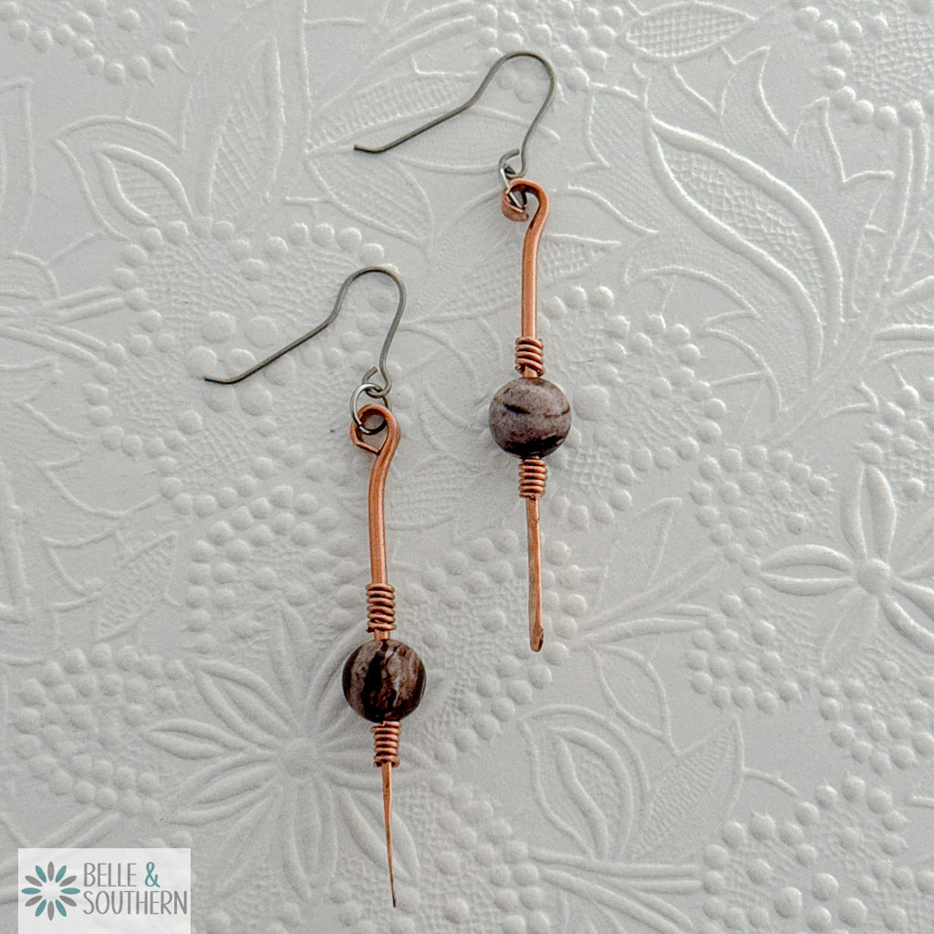 Gem on a Stem Zebra Jasper earrings on a white embossed background
