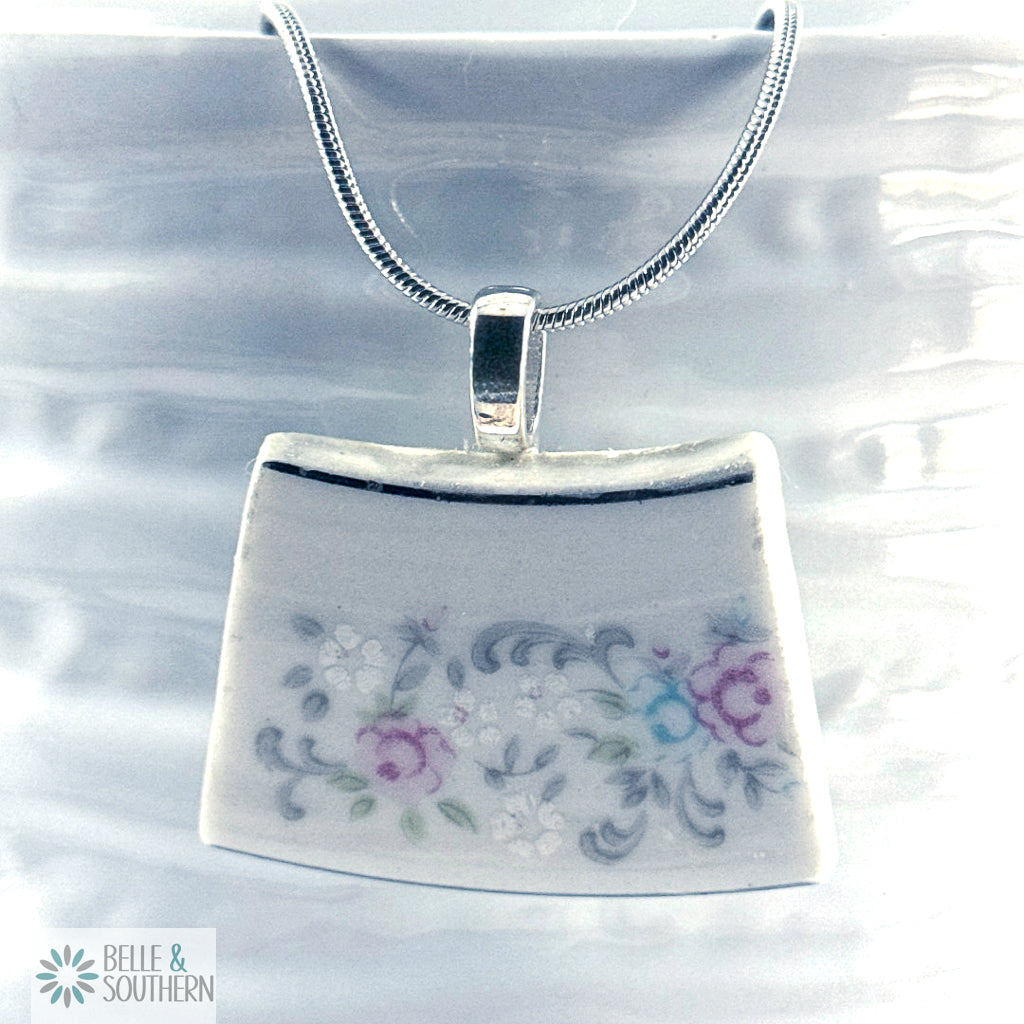 Decorative pendant with floral design on a clear background, featuring the brand 'Belle & Southern'.