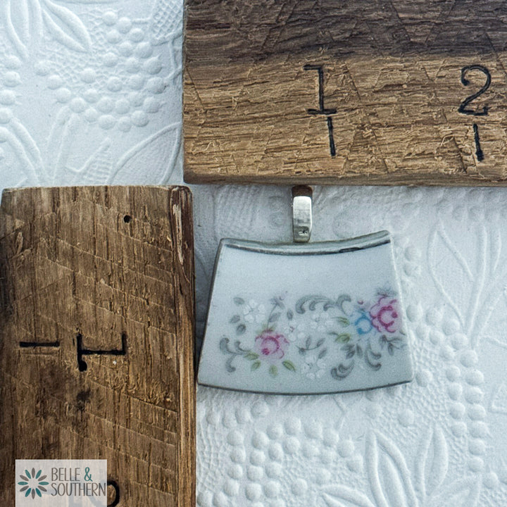 Small embroidered pouch with floral design on a wooden block, featuring the brand 'Belle & Southern'.