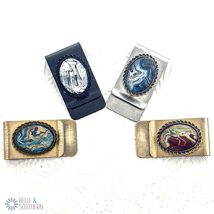 Four money clips with engraved designs on a white background, featuring the brand 'Belle & Southern'.