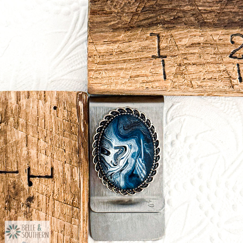 Stainless Steel Silver Money Clip with Blue and white marbled stone looking paint with decorative border by ruler, branded 'Belle & Southern'.