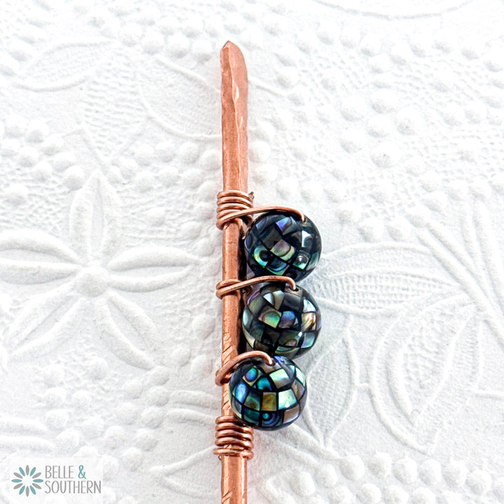 Upclose view of 3 Mosaic Abalone Shell Beads on textured copper hair stick