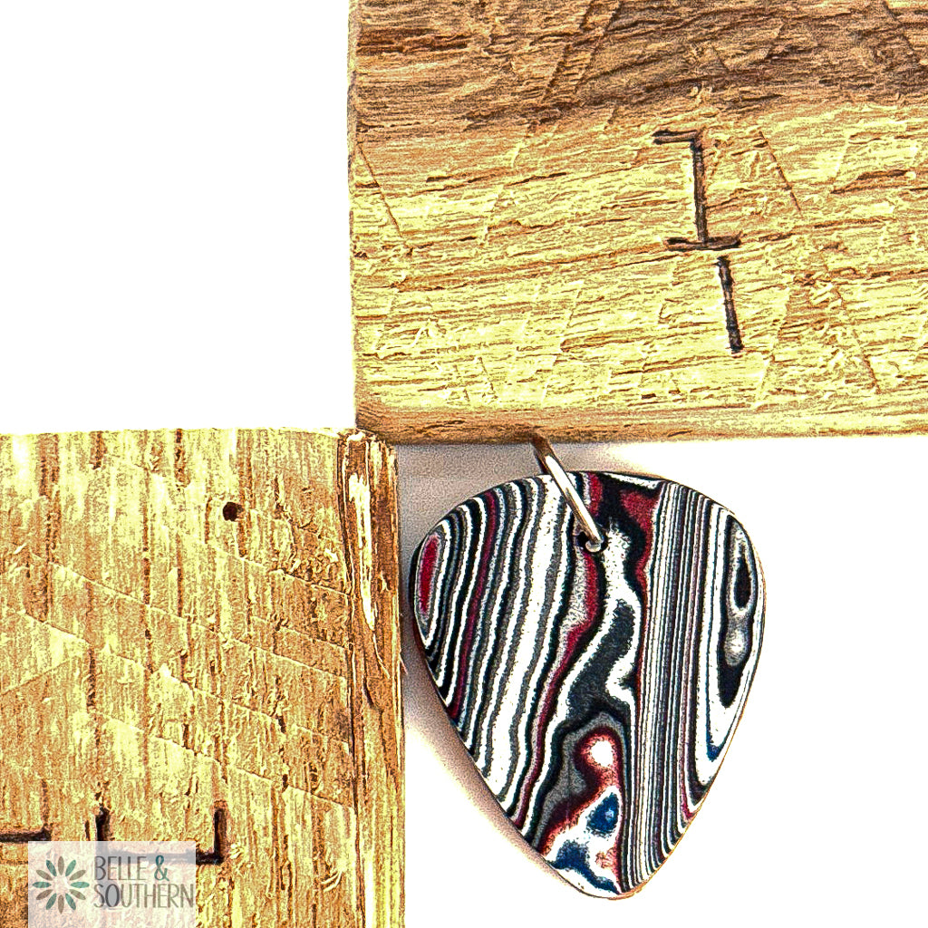 Fordite Pendant Formed in a Guitar Pick Shape with Copper Guitar Pick Backing