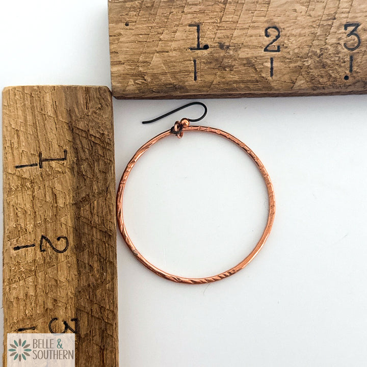 Copper hoop earring on a wooden ruler for scale, with 'Belle & Southern' branding.