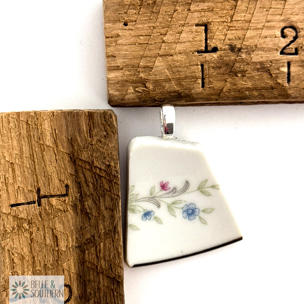 Quiet Bloom Fragment Necklace next to ruler for measurement