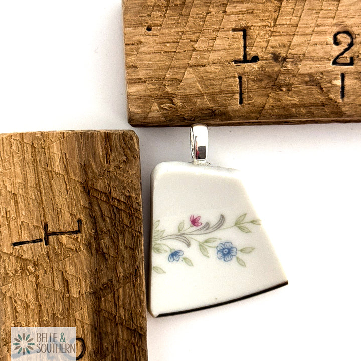 Quiet Bloom Fragment Necklace next to ruler for measurement