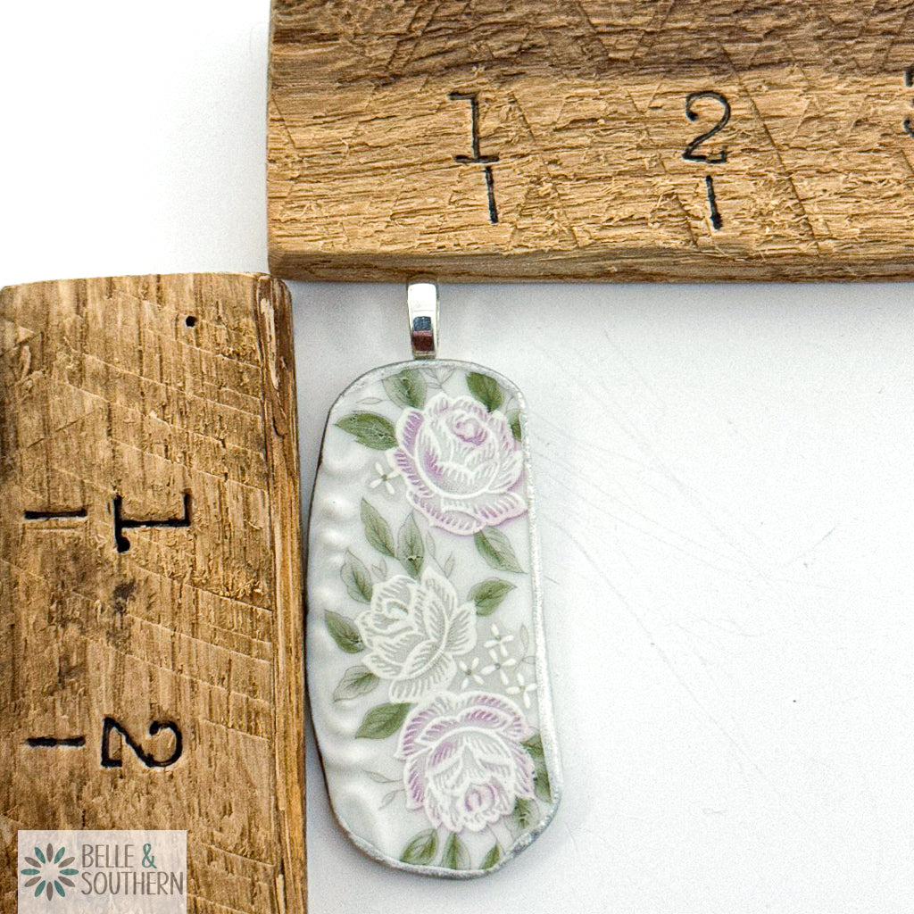 Rose Cascade porcelain fragment necklace displayed beside a ruler for scale