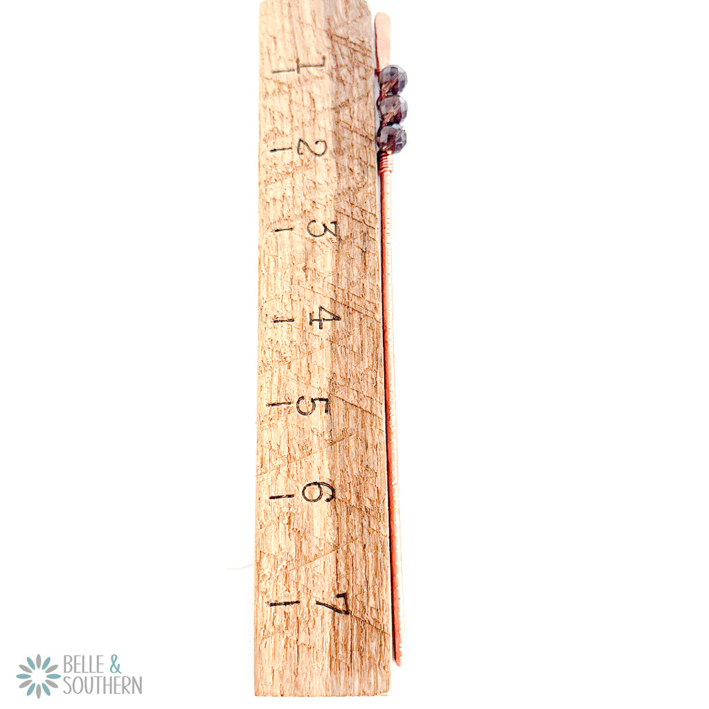 Smoky quartz copper hair stick pair shown beside a wooden ruler for length reference.
