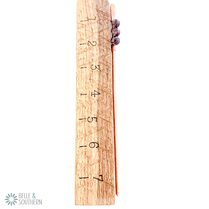 Smoky quartz copper hair stick pair shown beside a wooden ruler for length reference.