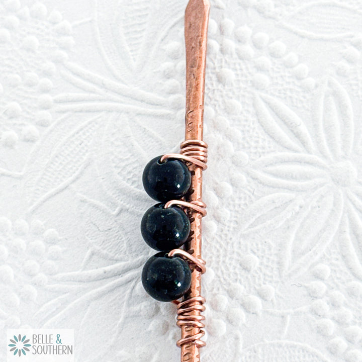 Upclose view of 3 Sparkling Green Goldstone Gemstone Beads on textured copper hair stick