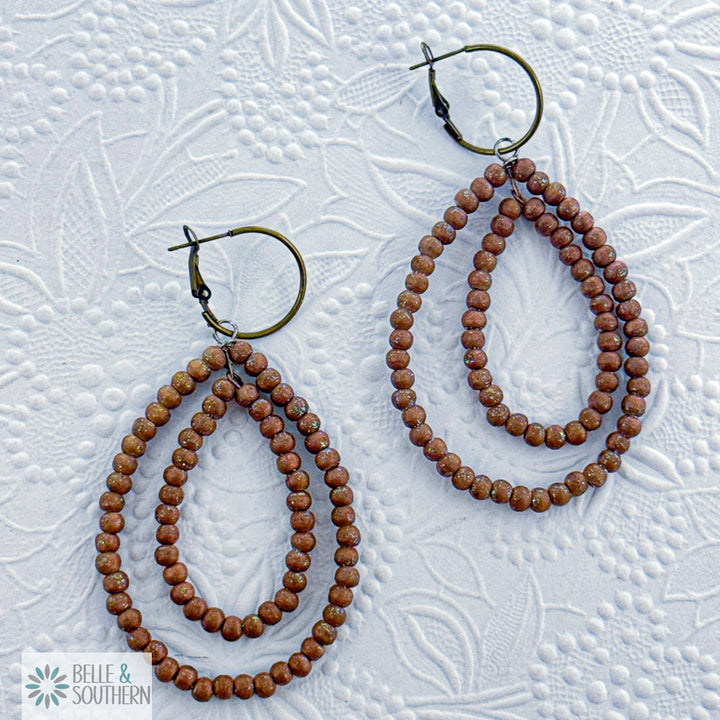 Lightweight hand-dyed light brown teakwood bead earrings with secure bronze-tone half-inch hoop design