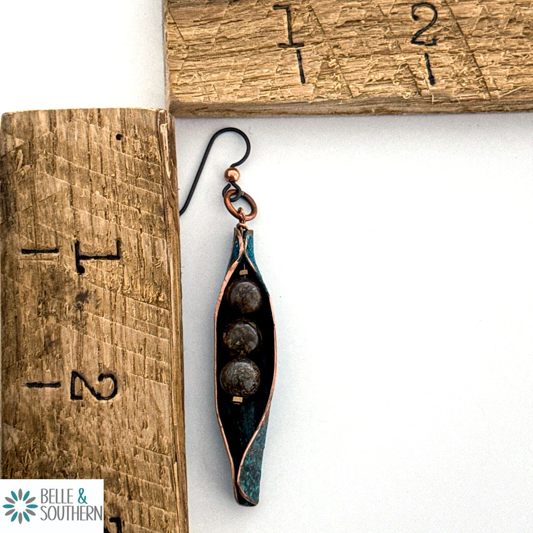 Three Beads in a Moss Earrings next to ruler