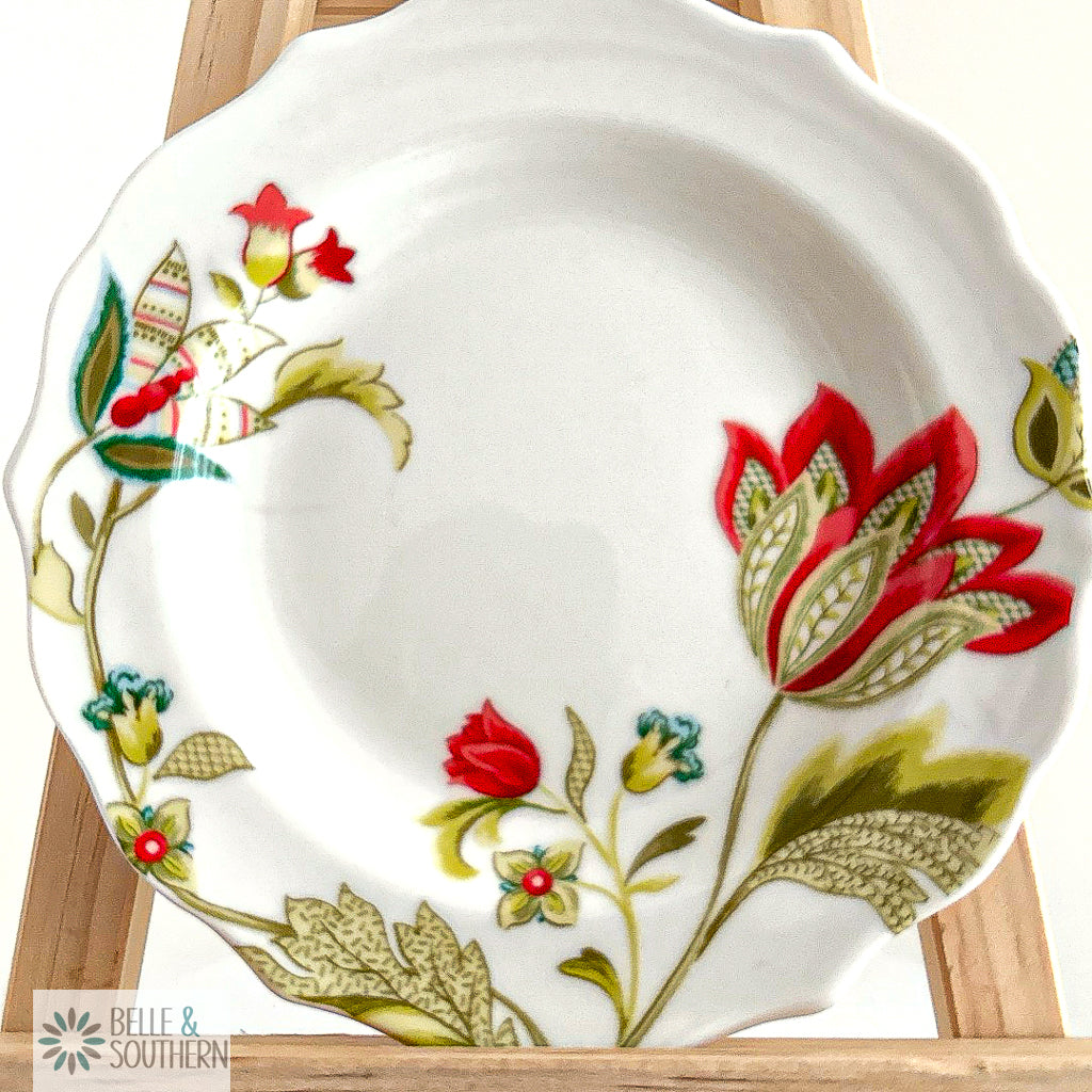 Floral china plate with red, green, and teal flower pattern 