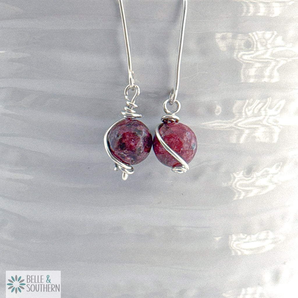 Silver earrings with Aggie Maroon Jade  gemstones on a white vase , featuring the brand 'Belle & Southern'