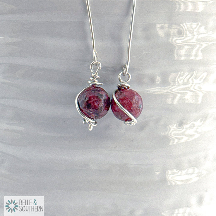 Silver earrings with Aggie Maroon Jade  gemstones on a white vase , featuring the brand 'Belle & Southern'