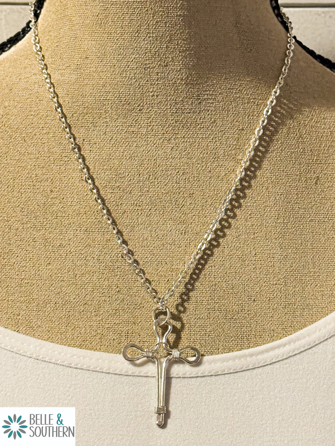 Wire Cross Necklace on mannequin

